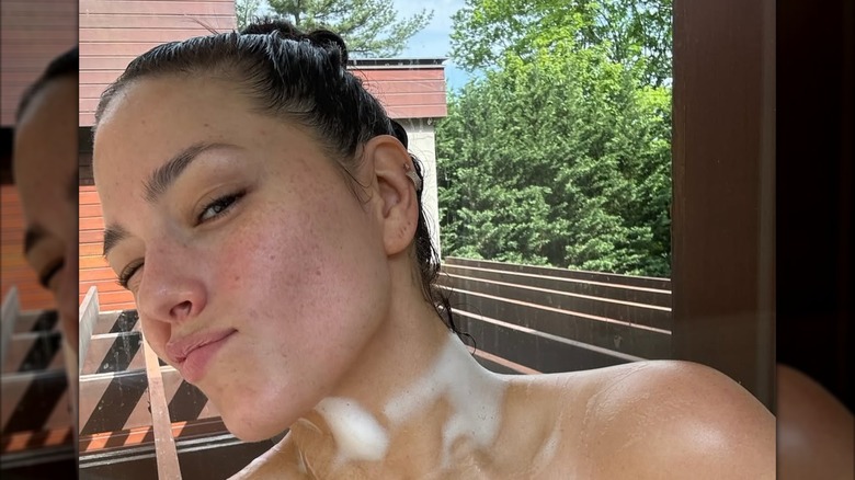 Ashley Graham posant sans maquillage en prenant un bain