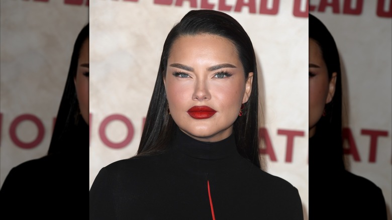 Adriana Lima est vue avec des sourcils foncés et une lèvre rouge vif lors d'une projection de film en 2023